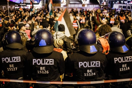 Police officers in Berlin stand guard during a protest in solidarity with Palestinians  