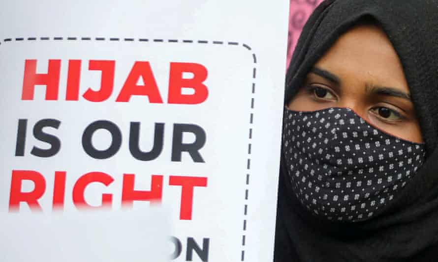 A Muslim student holds a placard during a protest by Muslim Students Federation (MSF) against the hijab ban