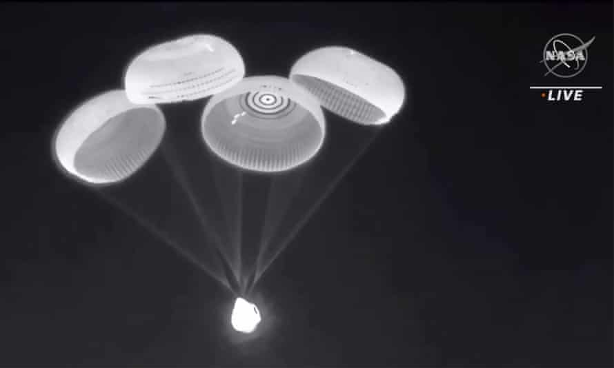 Parachutes are deployed from the SpaceX Dragon capsule
