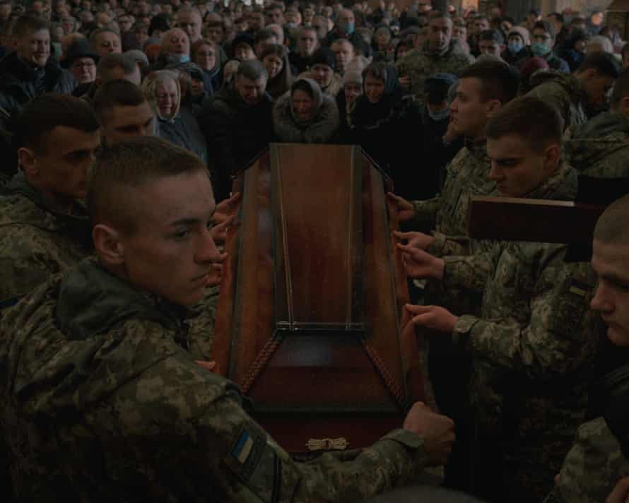 Soldiers carry the coffin of a fallen Ukrainian soldier out of the church after a mourning ceremony at Saints Peter and Paul garrison church in Lviv, 11 March