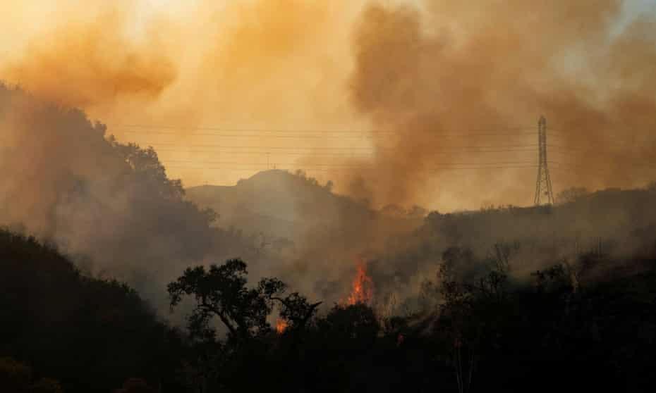 FILE PHOTO: The Bond Fire wildfire continues to burn next to electrical power lines near Modjeska Canyon, California, U.S., December 3, 2020. REUTERS/Mike Blake/File Photo