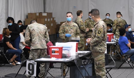 Army medical personnel wait to administer shots at the FEMA-supported Covid-19 vaccination site at Valencia State College on 25 April, the first day the site resumed offering the Johnson &amp; Johnson vaccine following the lifting of the pause ordered by the FDA and the CDC due to blood clot concerns. Most patients opted for the Pfizer vaccine which was also available.