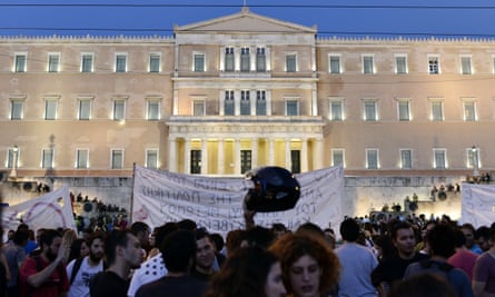 Riot police stand on the steps of the Athens parliament building, as leftist protesters hold an anti-EU demonstration on Sunday.