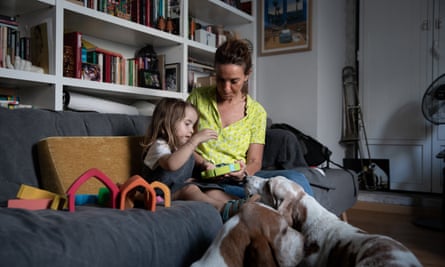 Margarida Custódio and her daughter Pilar in their living room with two dogs