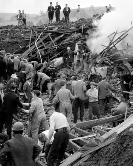 Rescue workers remove mud and rubble burying one of a row of seven houses at Aberfan in 1966.