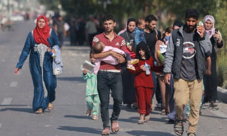 People fleeing northern Gaza reach the central Gaza Strip on foot via the Salah al-Din road on 5 November.