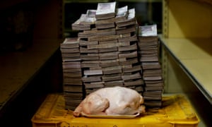 A 2.4 kg chicken is pictured next to 14,600,000 bolivars