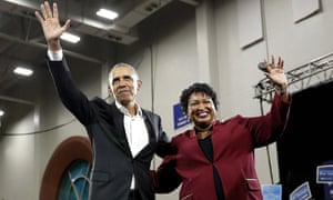 Barack Obama and Stacey Abrams wave to the crowd during a campaign rally at Morehouse College in Atlanta.