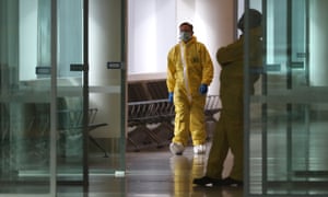 Authorities watch before passengers disembark for immigration procedures on March 30, 2020 in Perth, Australia.