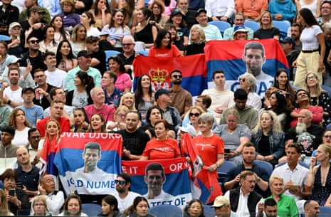 Fans of Novak Djokovic pose for photos in the stands during his third round match against Tomas Martin Echeverri.