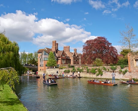 People in boats on the River Cam pass the Jerwood Library at Trinity Hall