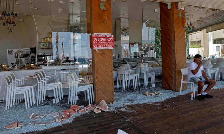 A man sits at a restaurant attacked the previous night in the city of Bat Yam