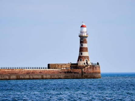 Roker’s red-brick pier juts out to sea, with red and white lighthouse at the end