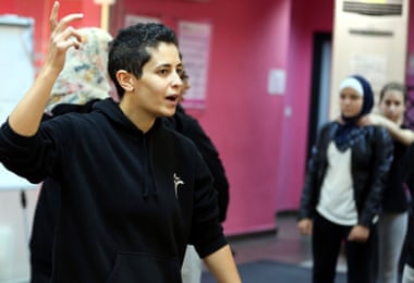 Lina Khalifa, founder of SheFighter, talks to students at the studio in Amman.