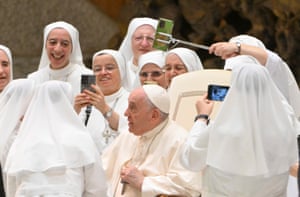 Rome, Italy. Pope Francis poses for a group selfie with nuns during the weekly general papal audience in Paolo VI Hall in the Vatican