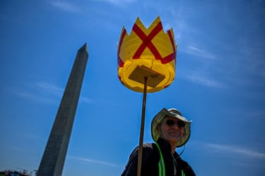 a person holds a handmade crown with red Xs on it