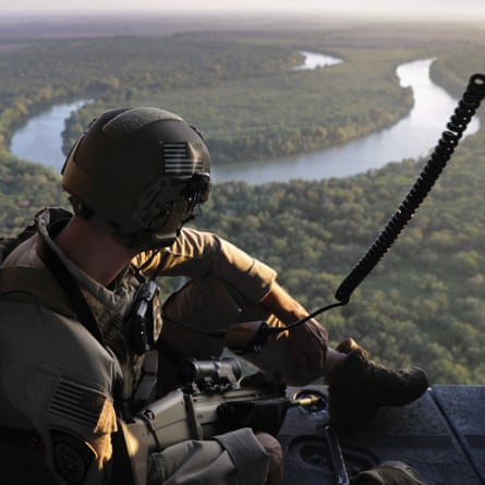 A US Customs and Border Protection agent searches for undocumented immigrants during a helicopter patrol over the Rio Grande at the US-Mexico