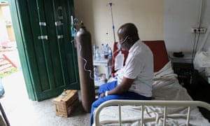 A patient breathes oxygen from an old tank, at the St. Joseph Covid-19 treatment centre in Kinshasa, Democratic Republic of Congo, on 24 December.