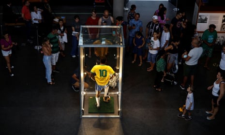 People leave tributes next to a waxwork of Pelé in Santos, Brazil.