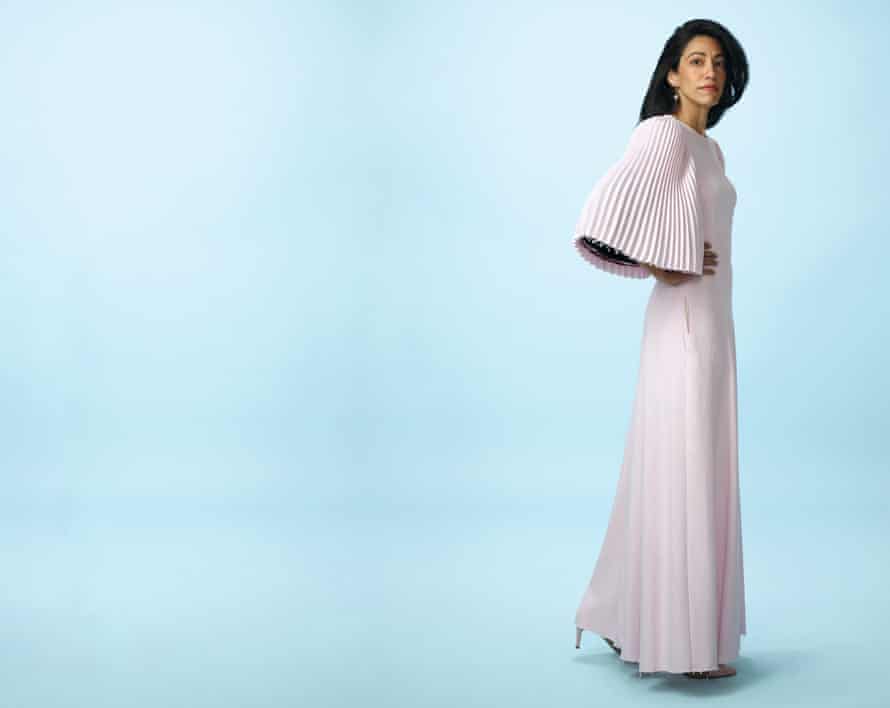 Huma Abedin in long pink dress against blue background, October 2021