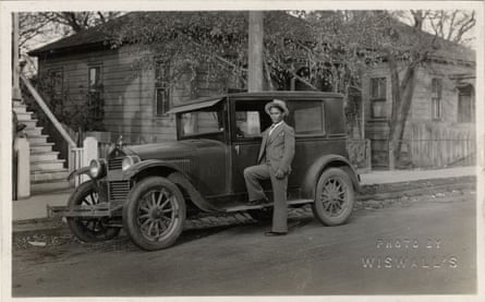 man in 1920s with car