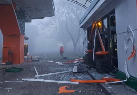 A rescuer is seen at a compound of a petrol station in Dnipro.
