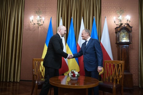 Polish prime minister Donald Tusk (R) shakes hands with Ukrainian prime minister Denys Shmyhal (L) during their meeting in Warsaw on Friday.