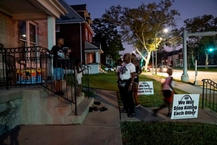 Chante Bass, center, tells her children and grandchildren to go inside for the night at their home in St. Louis.