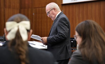a man in suit speaking in courtroom