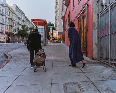 Two people walk up a San Francisco street during the early morning hours.