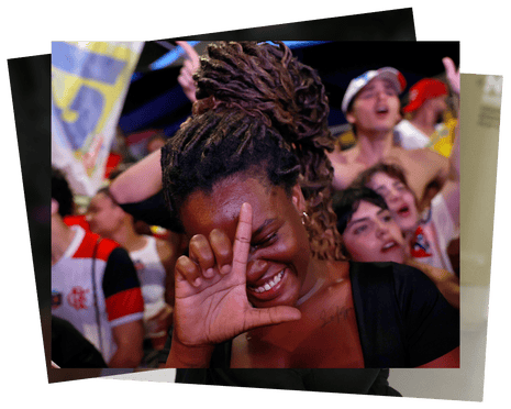 A Lula supporter smiles with closed eyes, gesturing near her forehead amid a cheering crowd