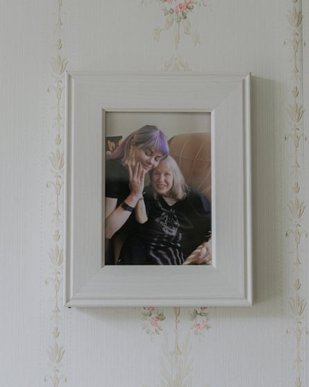 A photo in a frame shows a young woman and her mother smiling together