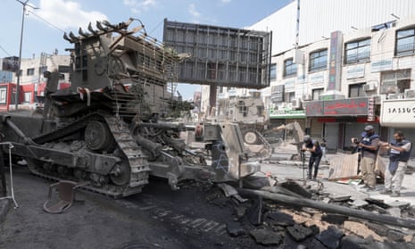 Israeli bulldozers chase away Palestinian journalists as week-long raid continues – video