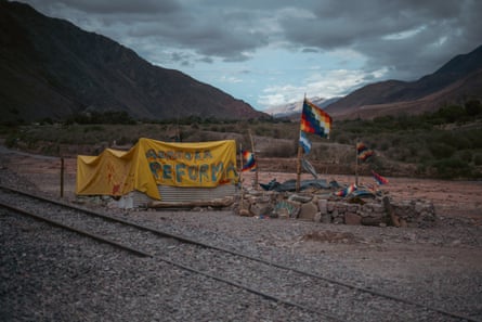 The protest camp on the road outside Purmamarca, with a darkening sky and mountains in the distance.