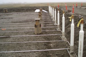 Thermosiphons installed at the Nikaitchuq oilfield on Alaska's North Slope, where they cool the ground and keep permafrost from thawing beneath a warehouse.