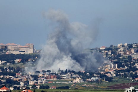Huge cloud of smoke rises from a city.