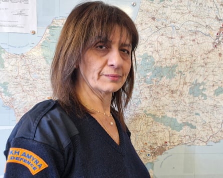 Maria Papa, who is about to leave her role as the civil defence’s chief officer in Cyprus, stands in front of a map of the country