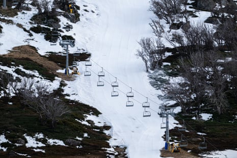 Many of the ski lifts are idle at Perisher Blue Ski Resort in NSW due to a lack of natural snow.