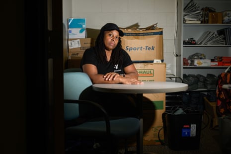 Woman sits at table near boxes