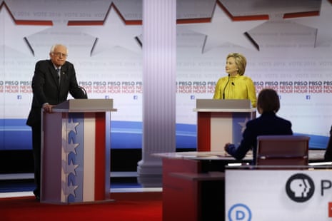 Bernie Sanders pauses as Hillary Rodham Clinton watches during the Democratic presidential primary debate.