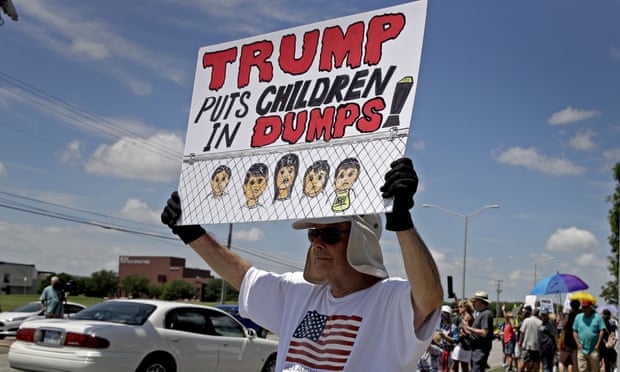A man protests the treatment of asylum seekers held in immigration detention centers, in Overland Park, Kansas.