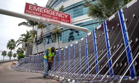 Workers install a flood barrier to secure Tampa General Hospital in anticipation of Hurricane Ian in Tampa, Florida on 27 September 2022.