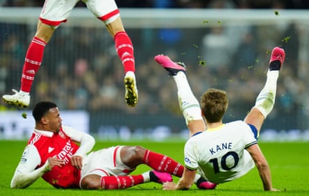 15 January 2023Harry Kane of Tottenham falls to the turf after a challenge from Gabriel of Arsenal.