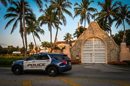 A police car is parked outside the Mar-a-Lago Club, home of former US President Donald Trump, on 3 April 2023