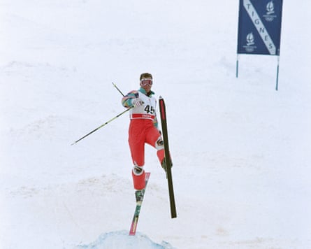 Grospiron takes on a mogul, arms and legs askew in an unorthodox skiing style.