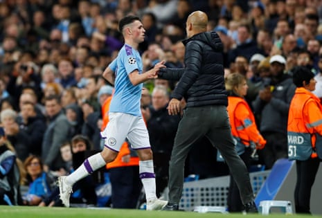 Phil Foden shakes hands with Pep Guardiola after being sent off.