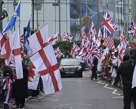 People carrying flags and banners gather in London for a march organised by far-right activist Tommy Robinson.
