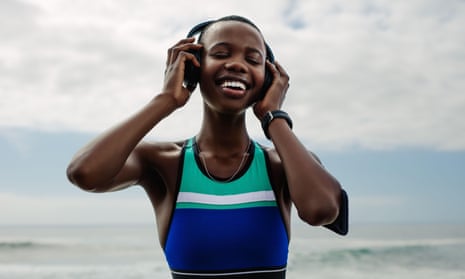 Smiling woman with headphones listening to music