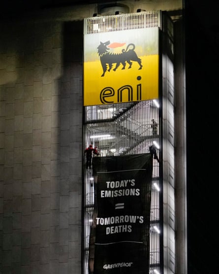 A banner reading ‘Today’s emissions, tomorrow’s deaths’ on a building with an Eni logo