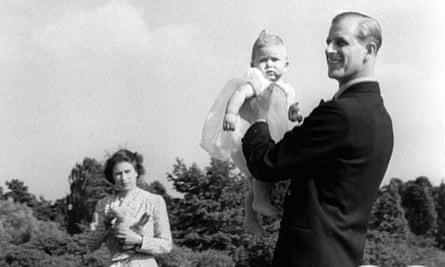 Prince Charles is held up by his father, Prince Philip, in 1949.